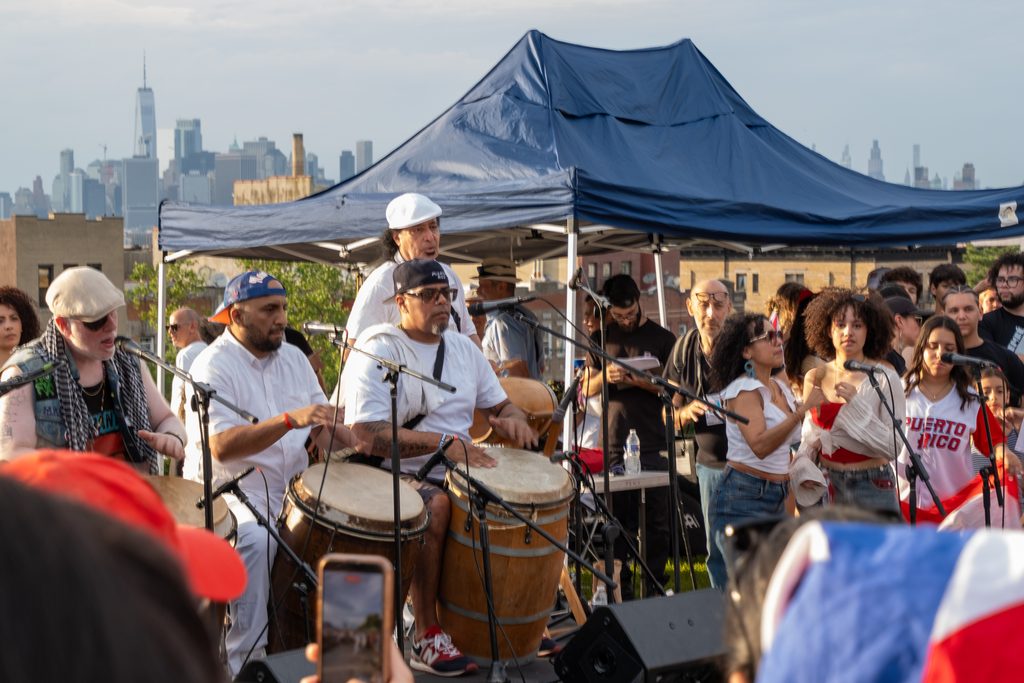 Musicians at the end of the Sunset Park parade, on the top of the hill with Manhattan in the back